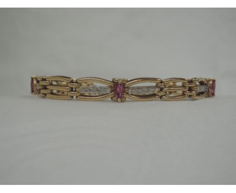 A 9ct gold decorative three bar gate bracelet having ruby and diamond chip decoration,  approx 13g