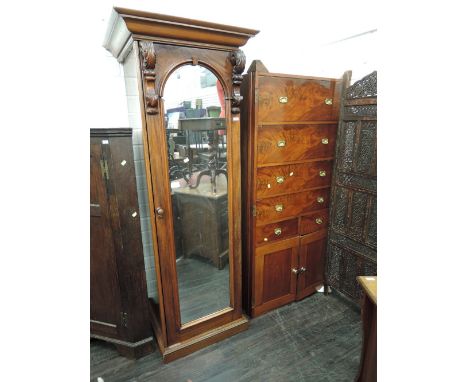 A mid Victorian mahogany part wardrobe section having arch/crest mirror door and a fitted drawer interior section