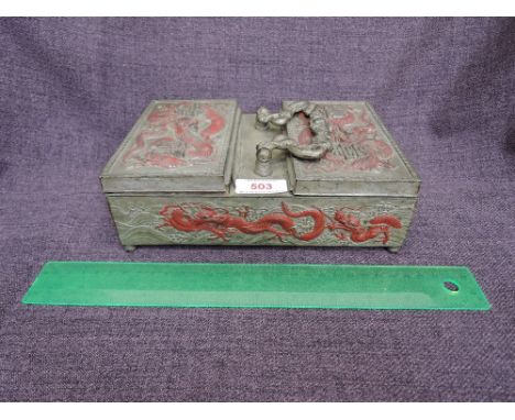 A cast metal Chinese caddy having painted mythological decoration