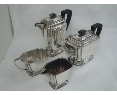 A four piece silver tea set of rectangular form having canted corners, angular handles and stepped pedestal bases, Sheffield 