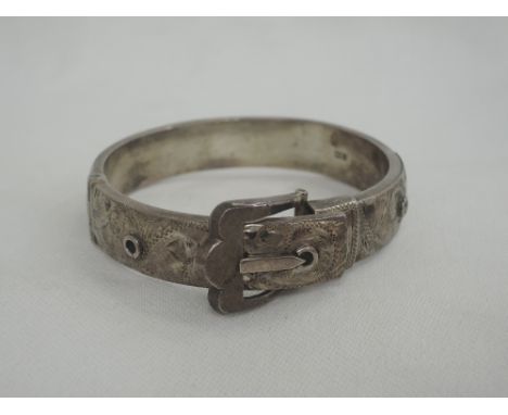 An HM silver hinged buckle bangle having engraved scroll decoration 