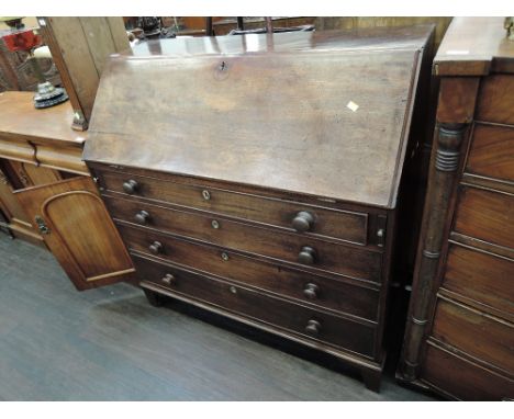 An early 19th century George III mahogany bureau having fitted interior, on four long drawers and bracket feet