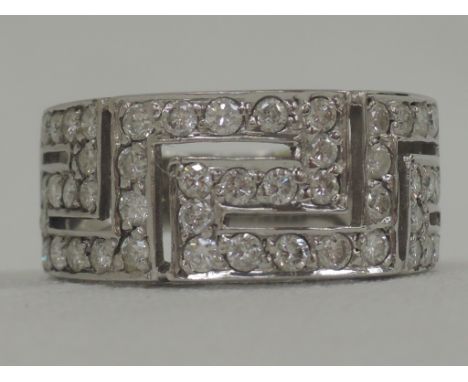 A lady's 18ct white gold band ring having diamond chip  Greek key decoration,  size K/L