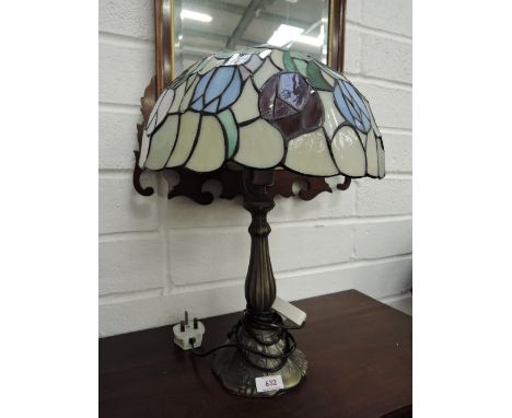 A Tiffany style reproduction table lamp having stylised shade in blue/green