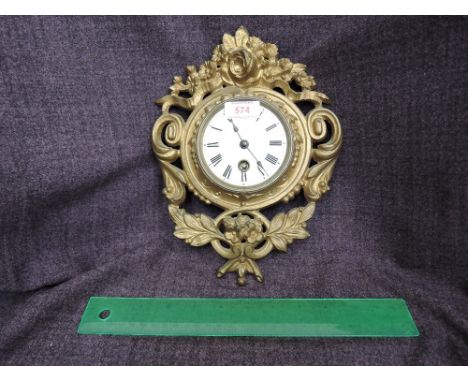 A late 19th/early 20th century cast metal gilt effect frame wall clock in the French style having enamel face and Roman numer