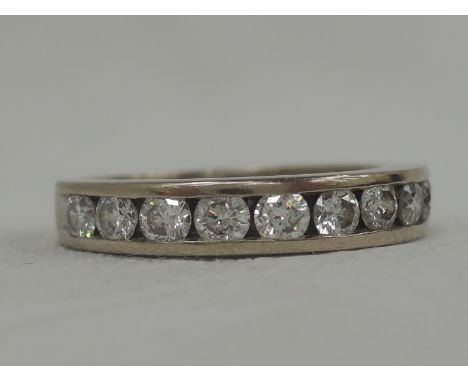 An 18ct white gold half eternity ring having twelve channel set diamonds, approx 1ct, size K