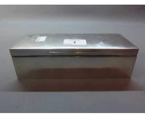 An art deco silver cigarette box with engine turn design and retailed by Asprey's.