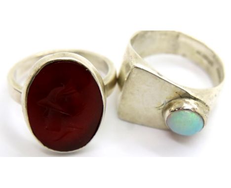 Hallmarked silver opal set ring and an orange stone Intaglio white metal example, both size I, combined 9g. P&amp;P Group 1 (