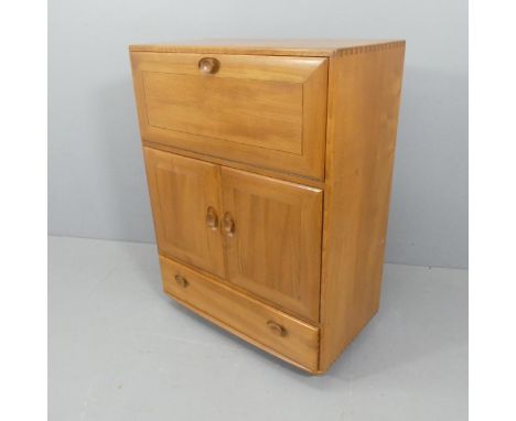 ERCOL - A mid-century model 469 bureau / drinks cabinet, with fall front, two cupboards and a drawer under. Width 83cm, heigh