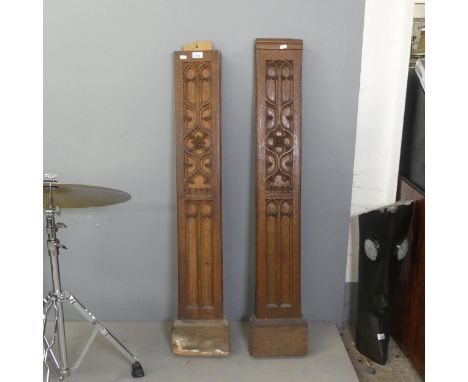 Two Arts and Crafts style carved oak columns, originally from a mantelpiece. Tallest width 22cm, height 124cm.