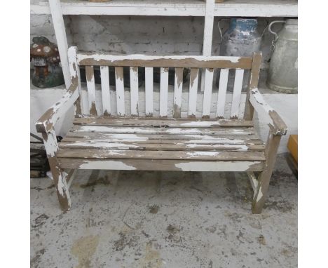 A weathered painted teak slatted garden bench. Overall length 123cm, height 83cm, depth 62cm.