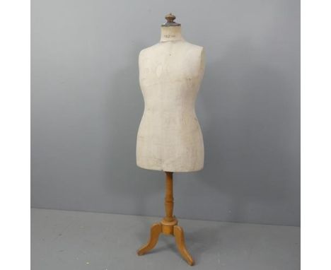 A vintage shop mannequin on turned wooden stand with tripod base. Labelled for Stockman. Height 160cm.