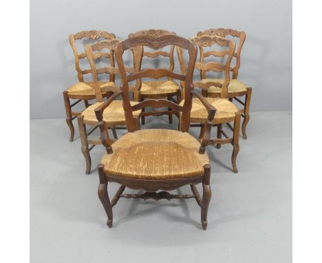 A matched set of six French oak ladder-back rush-seated dining chairs. (5+1)