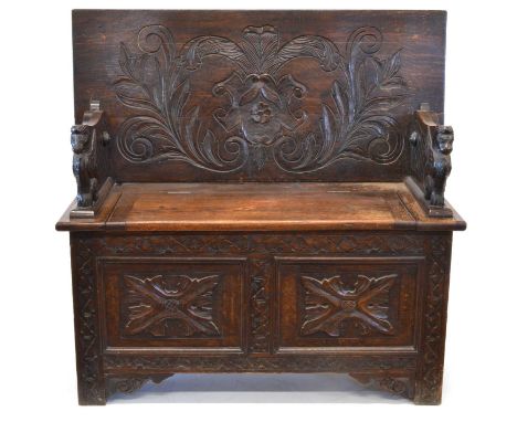 Victorian Carved Oak Monks Bench Victorian gothic carved oak monks bench, the hinged top decorated with the Prince of Wales f