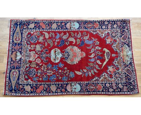 Iranian Kashan Rug Iranian Kashan rug, red field with foliate and boteh decoration around a central floral bouquet and parrot