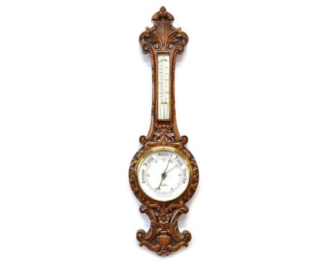 Aneroid Barometer by Aubrey Franks, Manchester Late 19th century carved oak aneroid wheel barometer signed A. Franks, Manches