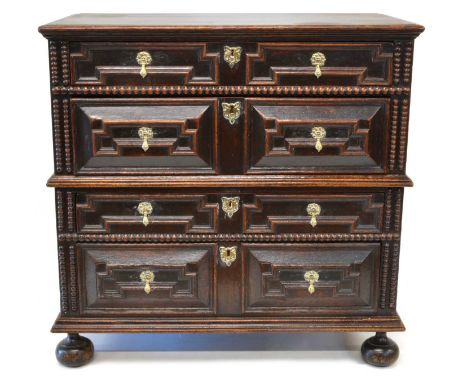 A late 17th century oak geometric moulded chest of drawers. A late 17th century oak geometric moulded chest of drawers in two