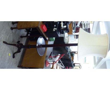 A modern mahogany standard lamp, incorporating a tray table, raised on a tripod base  66''h       RAM