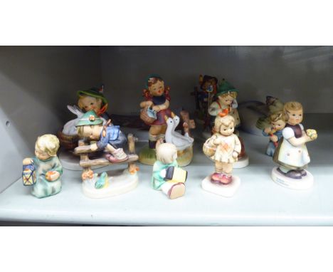 Twelve Goebel Hummel china figures: to include a young boy, sitting beside three rabbits  4''h       OS3