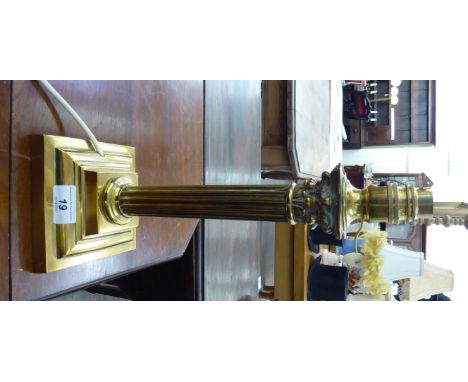 A modern brass table lamp with a reeded column and a Corinthian capital, on a stepped plinth  14''h       LAB