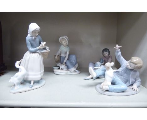 Ceramic ornaments: to include a Nao porcelain figure, a young boy playing with a spaniel  4''h       OS4