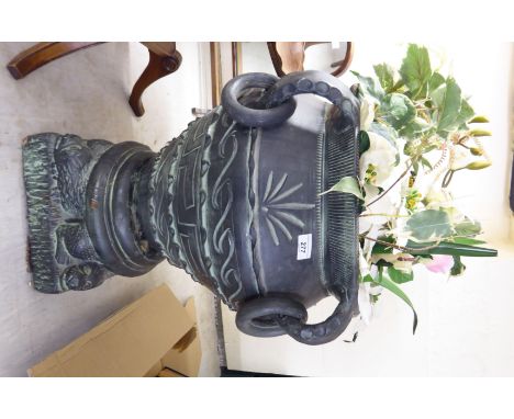 A pottery vase with ring handles, on a plinth  23''h  16''w with a display of artificial flowers       BSR