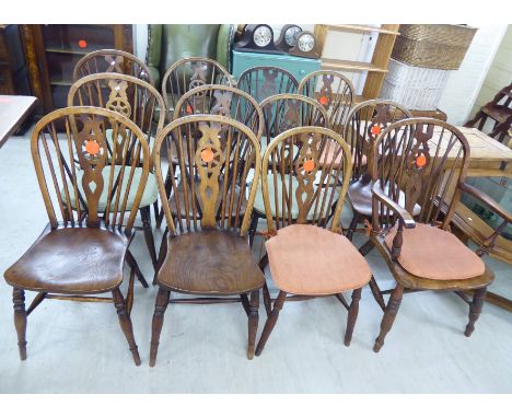 A matched set of twelve 19thC Windsor beech and elm framed hoop, spindle, splat back chairs, the solid seats raised on ring t