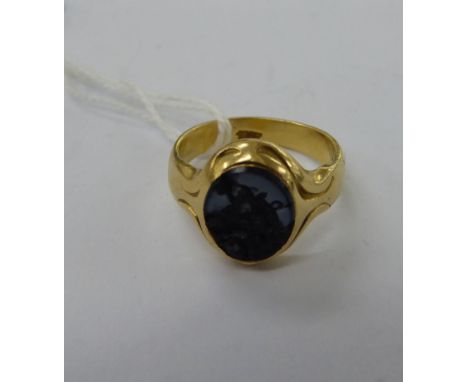 An 18ct gold signet ring, set with a black stone       11