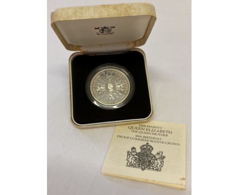 A 1980 silver proof coin commemorating the 80th birthday of The Queen Mother by Royal Mint.  In clear protective case with le