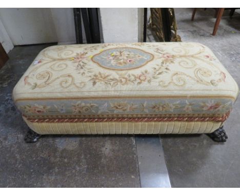 A VINTAGE LARGE NEEDLEPOINT FOOT STOOL WITH LION PAW FEET 130CM 