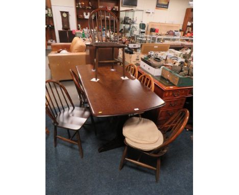 A DARK OAK ERCOL REFECTORY TABLE &amp; SIX HOOPBACK CHAIRS - NOTE: TWO CHAIRS ARE LIGHT