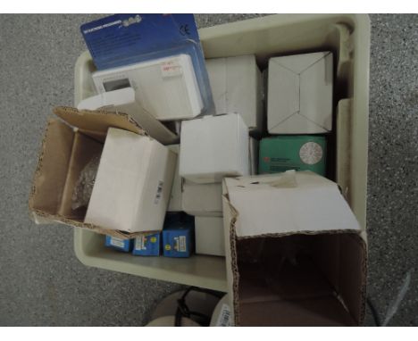 A box of various dot light bulbs, a thermostat control panel and two glass orchid fittings