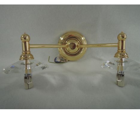 A brass and clear glass wall bracket
