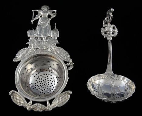 A silver tea-strainer, with milk-maid handle, stamped A Barratt & Sons, London, together with a continental caddy spoon with 