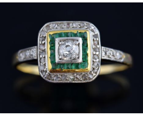 Art Deco period emerald and diamond ring set with centre diamond of 0.15 carat, within a band a of channel set emeralds and a
