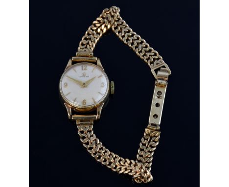  Omega Ladies 9 Carat gold  wrist watch  silvered dial with  applied gilt arrow hour markers and Arabic numerals, on 9 carat 