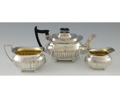 Edward VII silver three-piece tea-service, with gadrooned lower bodies and gilt interiors, by Walker & Hall, Sheffield 1903, 