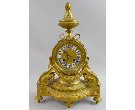 French Ormolu Clock with ribbon swag decoration white enamel and Blue Roman numerals, two train movement 43cm high.   Have no