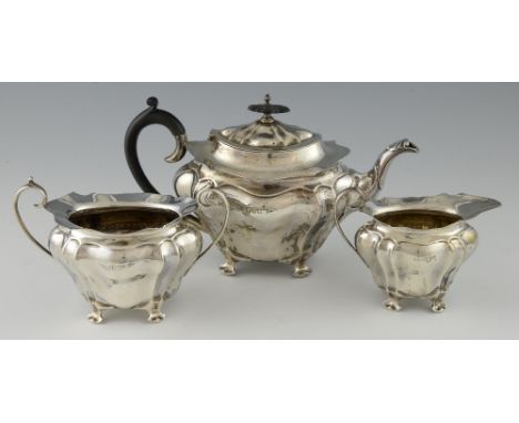 Edward VII silver matched three-piece tea-service, with lobed bodies and splayed rims, by Walker & Hall, the teapot Chester 1