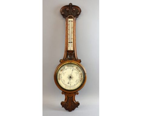 Oak Aneroid barometer in banjo shape with enamel white dial, thermometer above, 85cm high, trade label for Sotley and Lewis, 