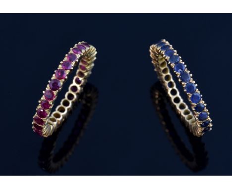 Sapphire and ruby set full eternity rings, mounted in yellow metal, tested as 14 ct gold, ring size M .   