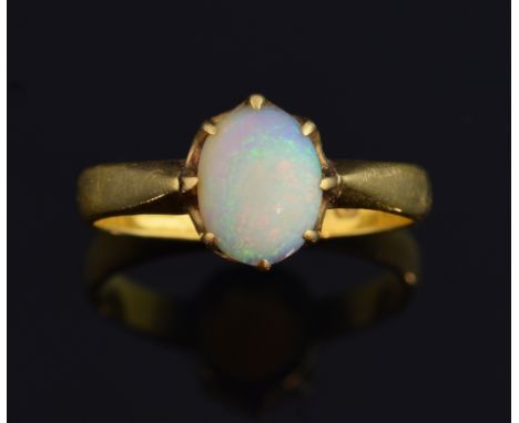 Opal set gold ring, the single oval stone estimated at 0.70 carats, set in 22 ct gold, hallmarked Birmingham 1904-1905, maker