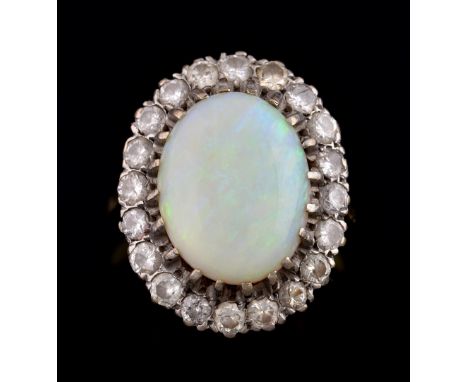 Opal and diamond cluster ring, with oval cabochon opal of  11.4 x 14.4 mm, within a border of diamonds in 18 ct gold mount, r