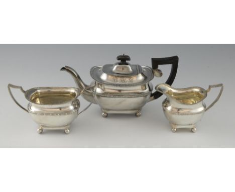 George V silver three piece tea service, comprising teapot (Chester), cream jug and sugar bowl, with gadrooned rims, each on 