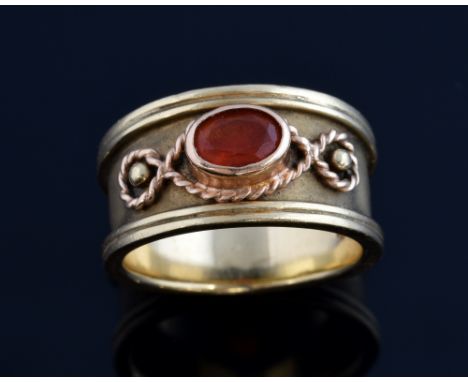 Fire opal set band ring, with rope detail setting, unmarked, tested as 9 ct gold, ring size P .   Gross weight 10 grams