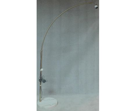 A chromium floor standing arc lamp on marble base, lacks shade. H.218 W.45 D.45cm 
