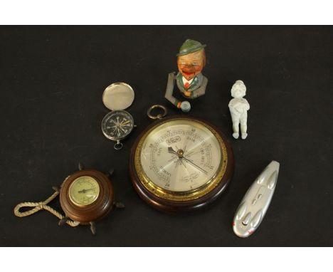 Two barometers, a vintage compass, bisque porcelain figure and a Bavarian painted nut cracker. H.3 Dia.13cm. (largest) 