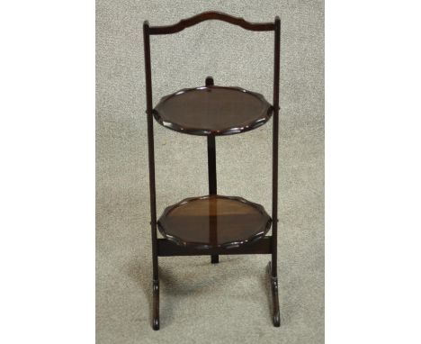 An early 20th century folding two tier cake stand. H.65 W.28 D.27cm. 