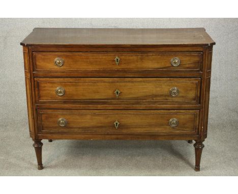 A 19th century French fruitwood commode chest of three long drawers on turned legs. H.87 W.119 D.50cm. 