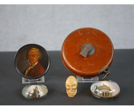 A Georgian hand painted papier mache snuff box painted with the portrait of a gentleman in a red coat, two paperweights, a ca